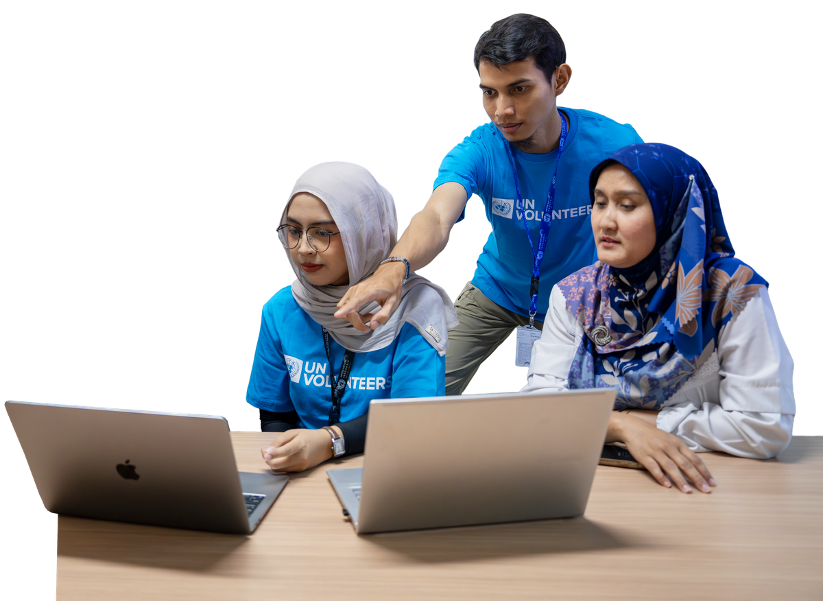 UN Volunteers collaborating at laptops